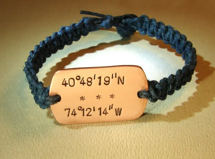 Personalized latitude longitude coordinates on a copper tag with woven blue hemp bracelet