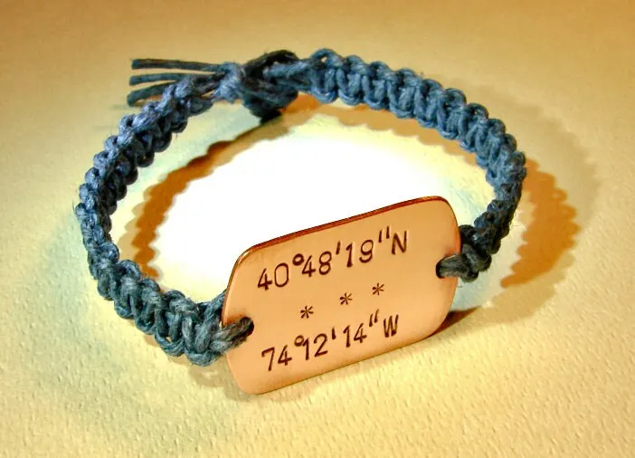 Personalized latitude longitude coordinates on a copper tag with woven blue hemp bracelet